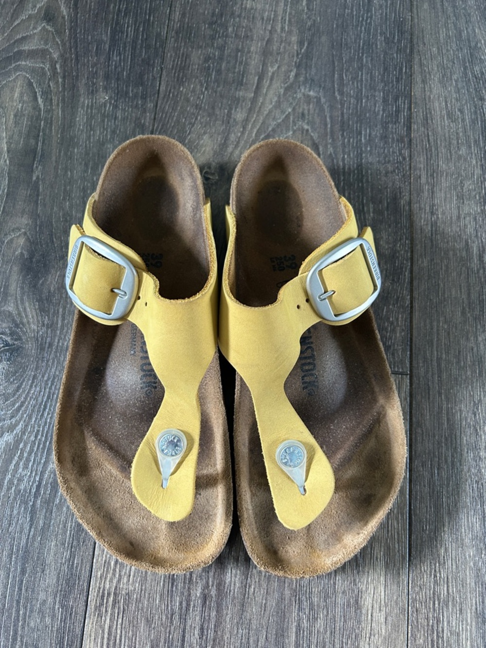 Women’s Birkenstock Yellow Toe-Post Sandals with large silver Buckle